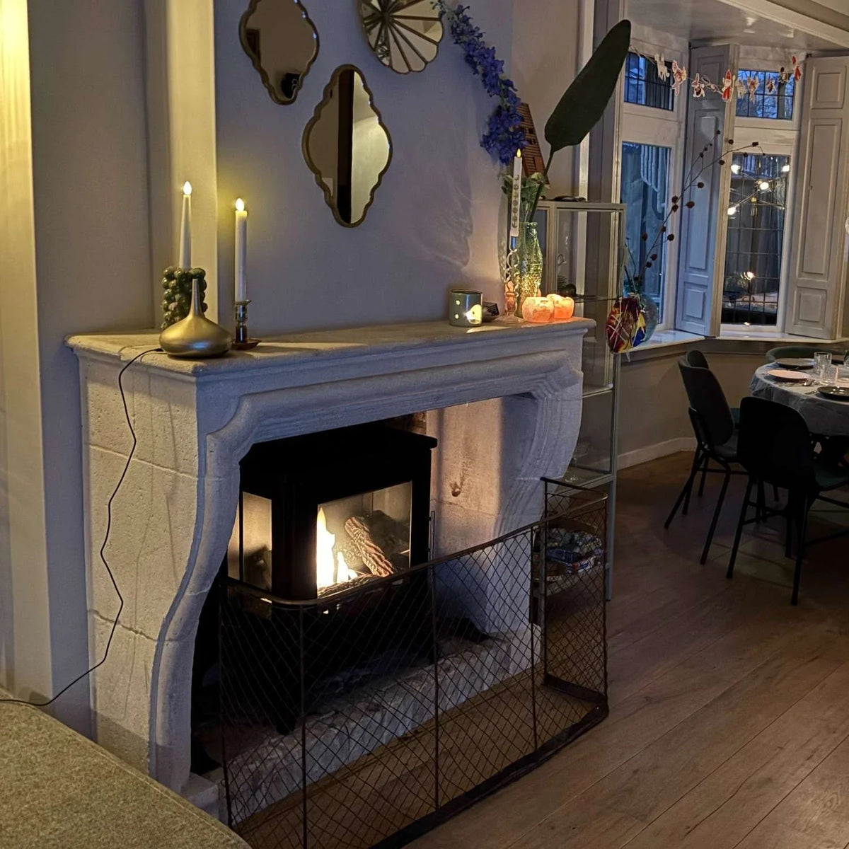 ScandiFlames Nashville black bioethanol stove lit and retrofitted into a customer's traditional stone fireplace surround